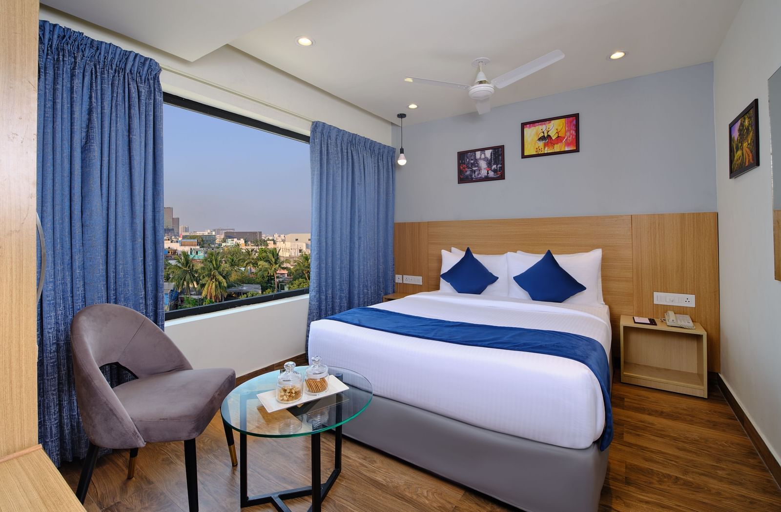 A room at Essentia Premier Hotel, Chennai with a double bed, a television and a work desk and chair