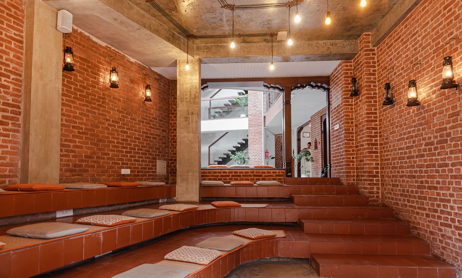 The bakhan kuthu which is The story telling Room with seating arrangement on the ground and which is subtly decorated with lighting - The Nanee