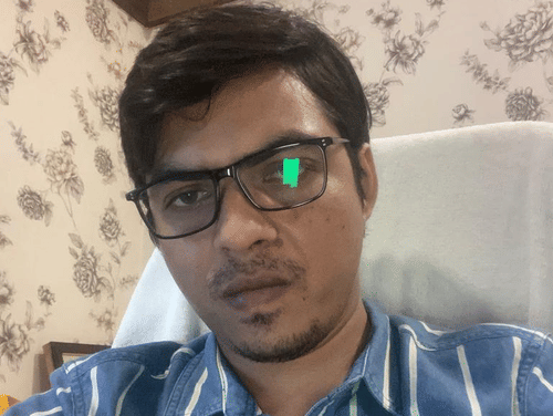 Yogendra Pratap Singh takes a selfie against a patterned wall.