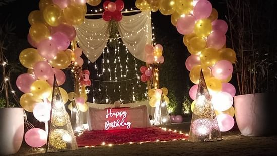 Outdoor decoration with balloons and poster at themis  mudhouse