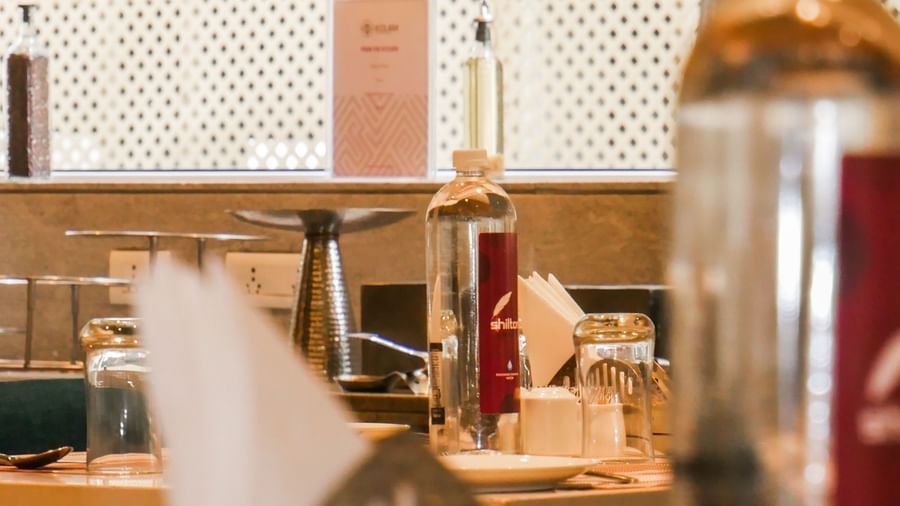 A blurred image of a restaurant interior, hinting at a lively dining atmosphere and warm lighting at Shilton Dee Cee.