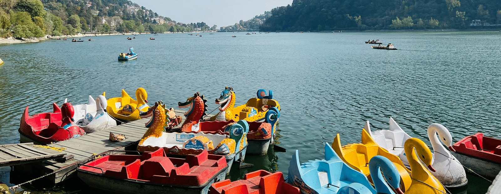 Picture of  lakefront scene with boats and people in the day.