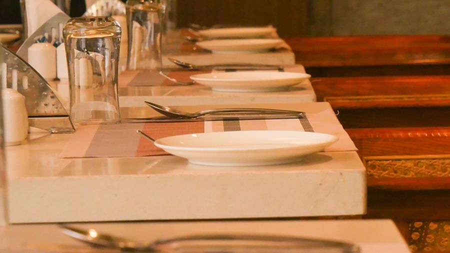 A close up of a dining table setting with a plate, cutlery, and glassware, ready for a meal at Shilton Dee Cee.