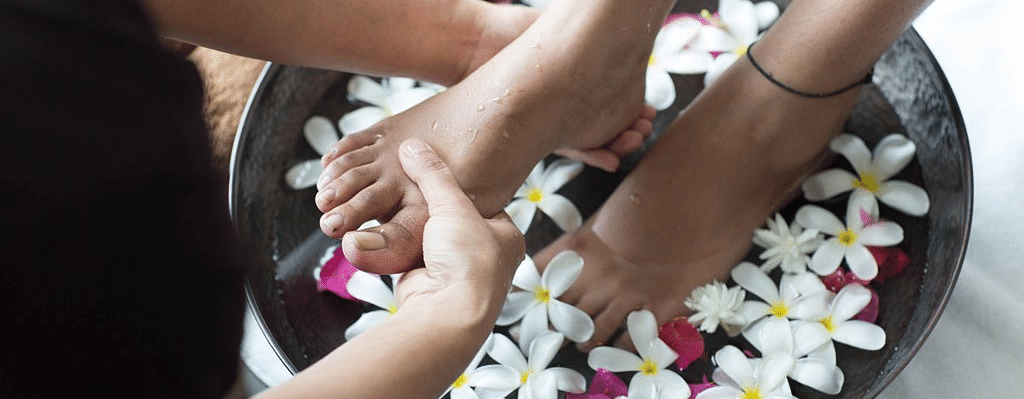 Foot massage with flowers.
