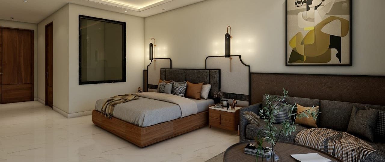 A bedroom with slightly low lighting featuring a double bed with an artistic head board along with a common seating area besides it. - Namaste Corbett