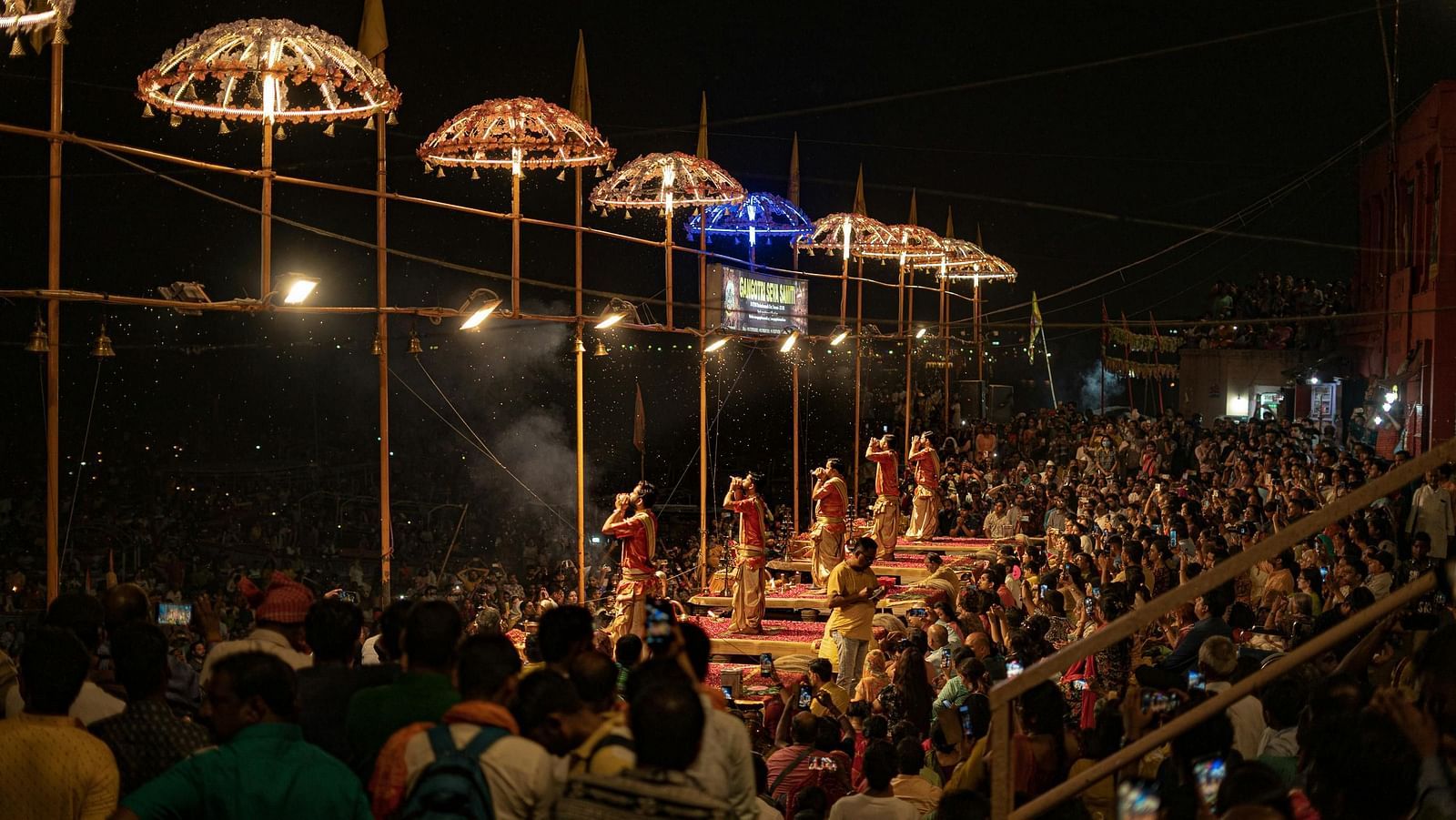 A wide angle shot of the Ganga Arti during the evening with a lot of devotees witnessing the ritual.