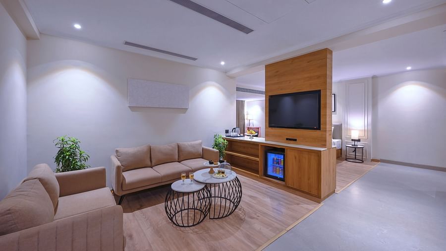 A living room featuring sofas, a TV cabinet and a coffee table - Royale Sarovar Portico, Agra