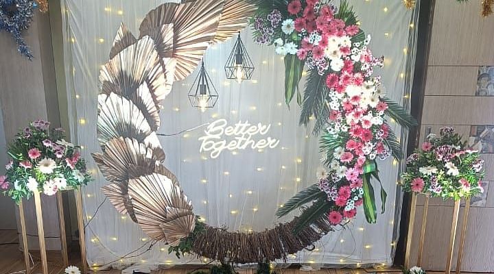 Image of a banquet hall with a large wreath as the backdrop at The Oriental Residency