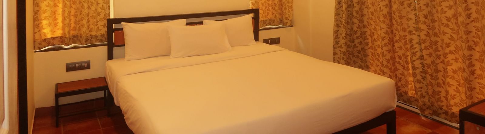 This comfortable bedroom at Forest Escape includes a double bed, bedside tables, and warm lighting for a restful stay.