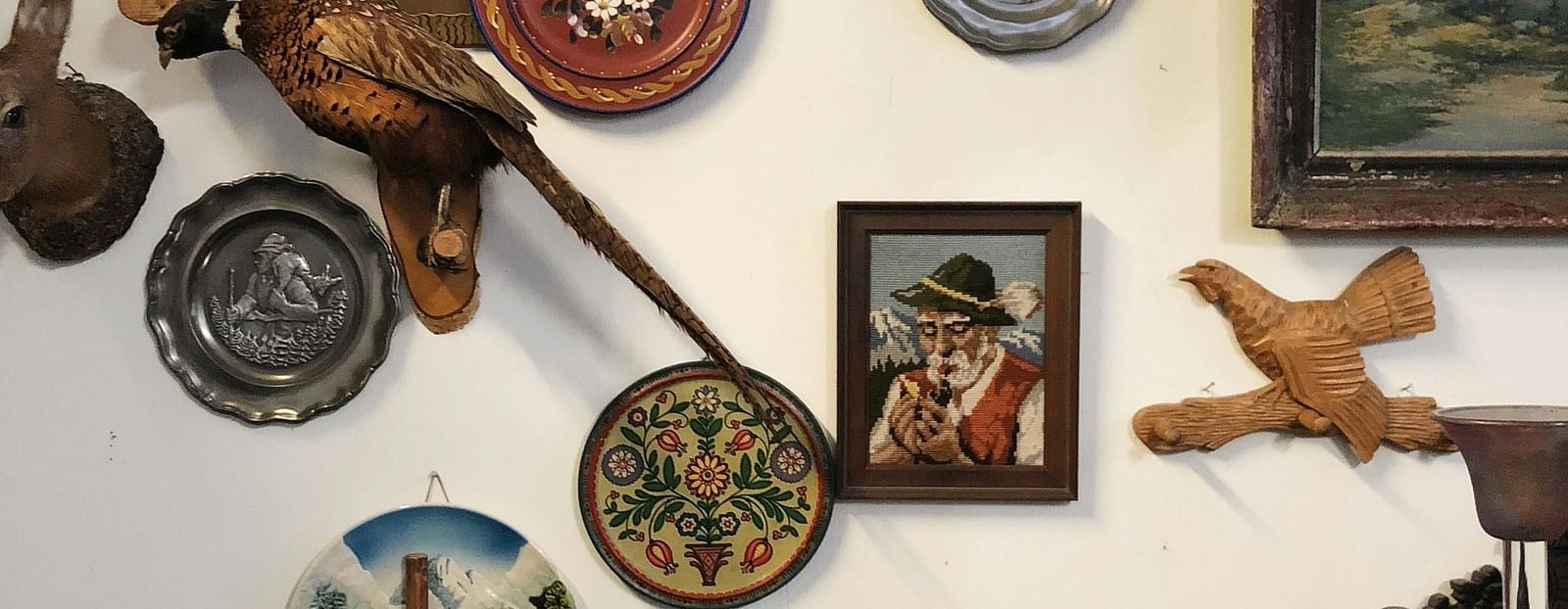 image featuring various wall hung artefacts on a white coloured wall in a museum