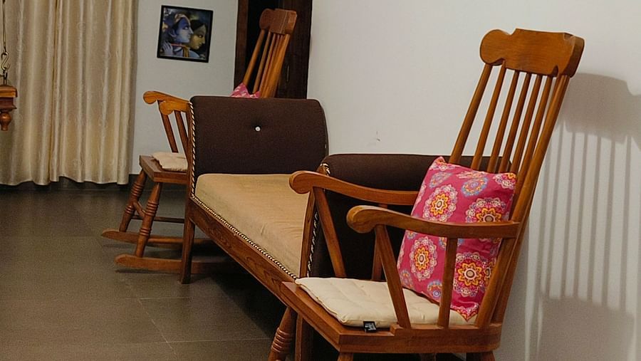 Another view of Two rocking chairs and a small couch kept in the  common area at Ananda Holiday Home, Wayanad 8