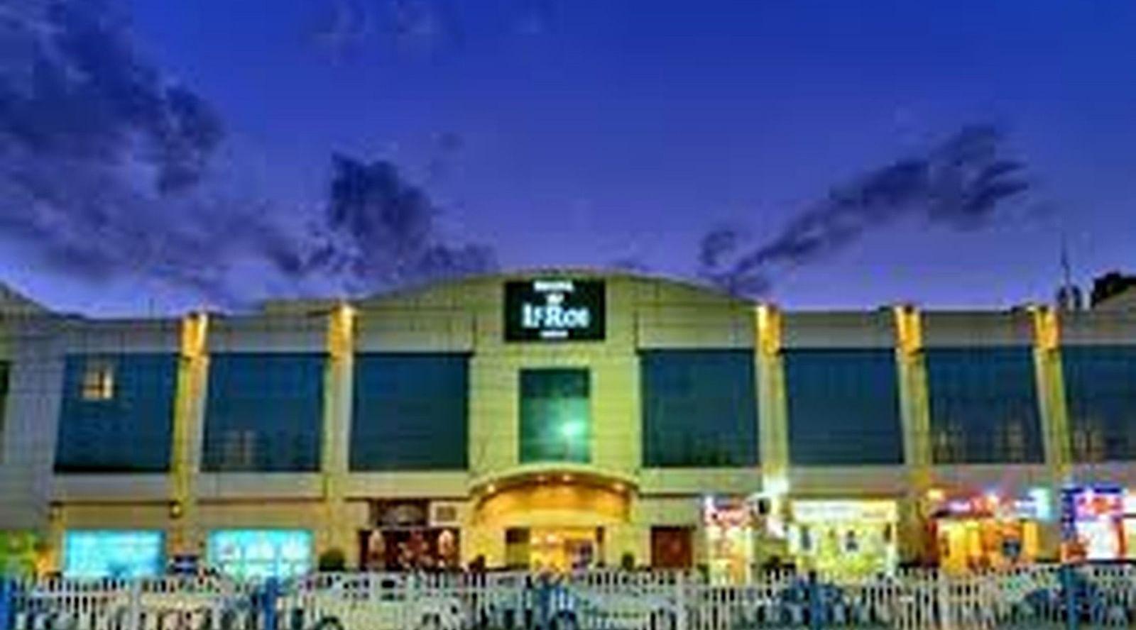 facade view of a hotel captured with night sky as the backdrop - le roi raipur hotel