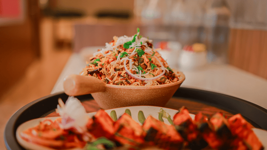 Grilled dish with a bowl of noodles on a serving plate at Hotel Mumbai House Digha, Airoli.