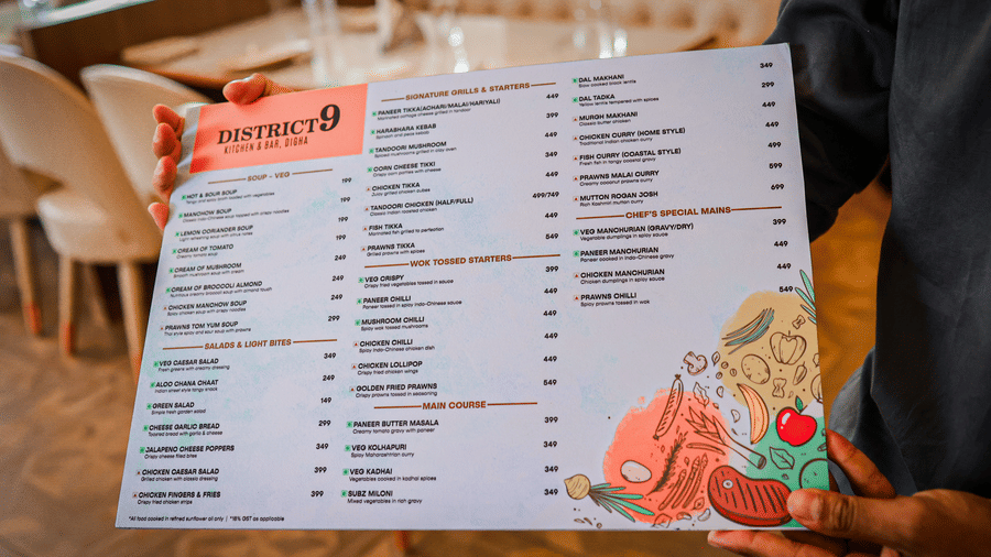 Guest holding a restaurant menu at Hotel Mumbai House Digha, Airoli.