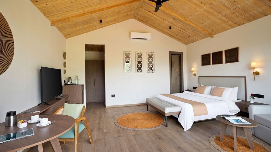 1 (1)A well-furnished bedroom with a king-size bed, wooden aesthetics, and an inviting ambiance.