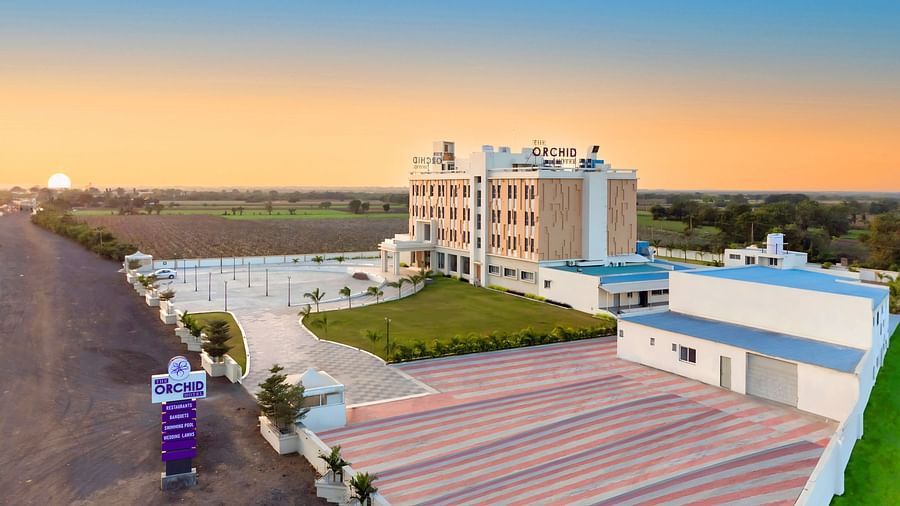 bird's eye view of The Orchid Hotel, Jamnagar with evening sky in the background