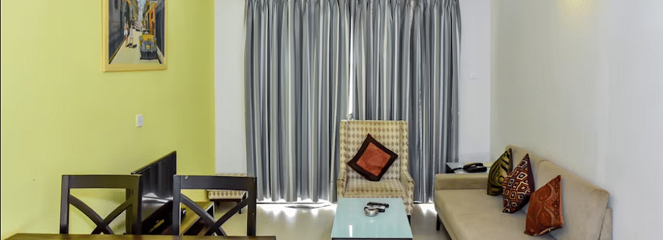 Living and dining space with a sofa and table at La Vida Studio Inn Goa.