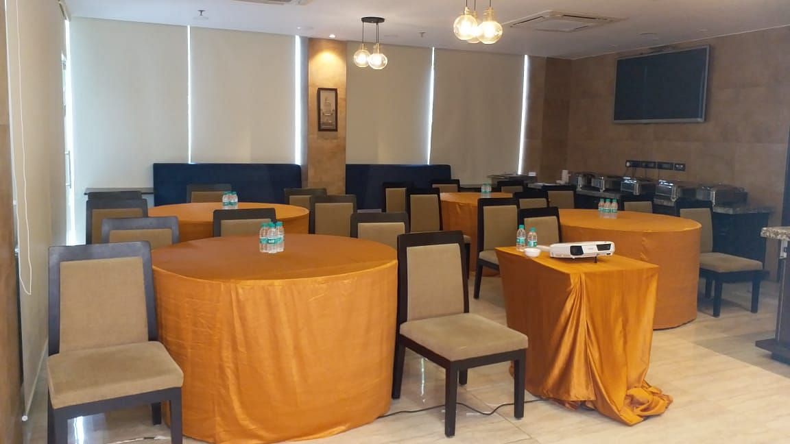 Chairs and round tables at a restaurant | Hotel Mumbai House, Andheri East