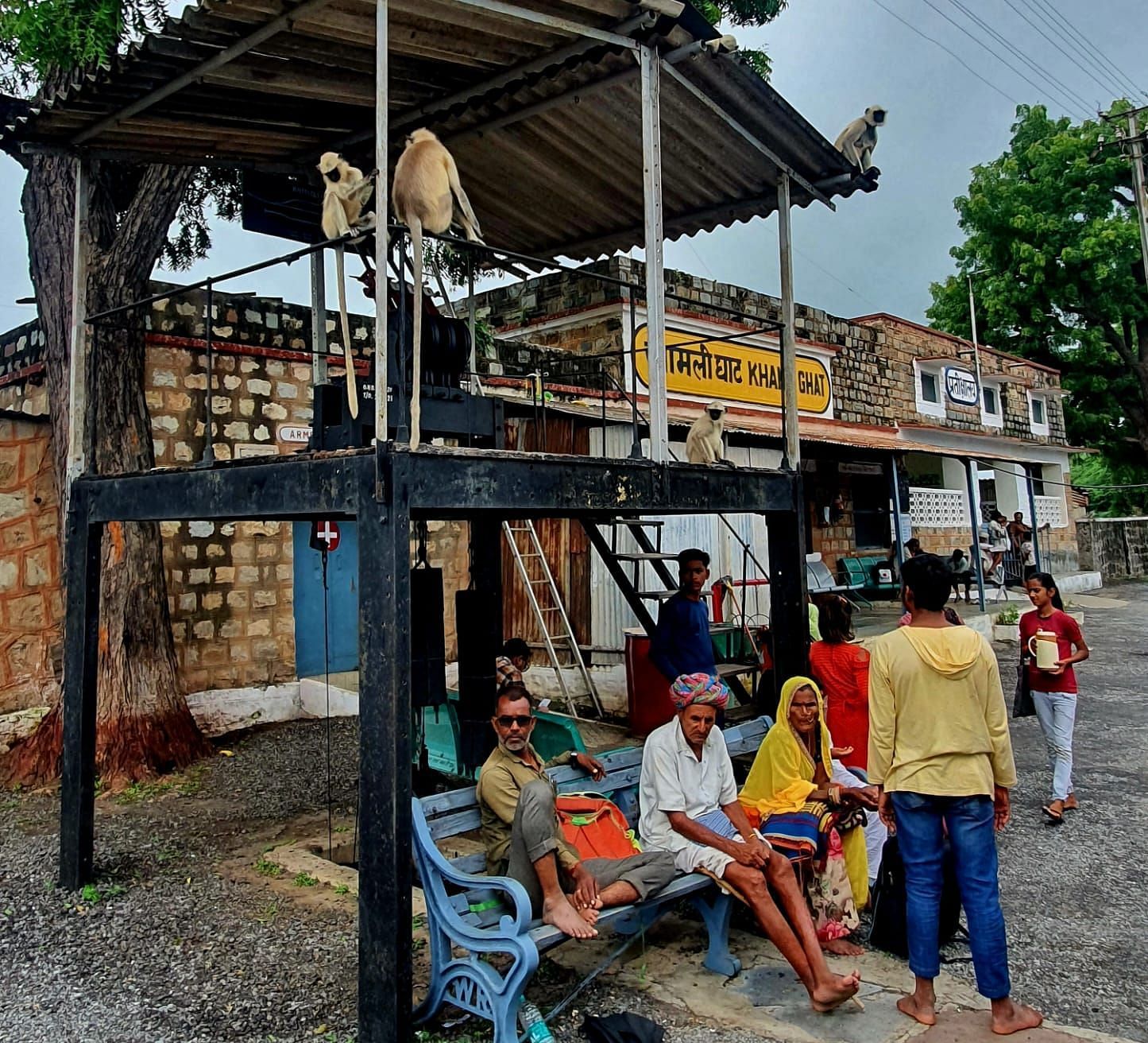 image of a few villagers waiting at a train station
