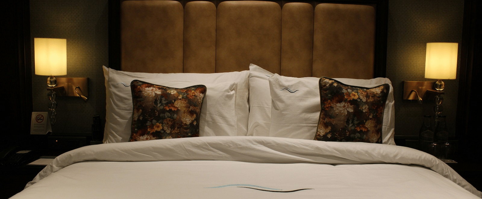 Front view of a neatly made bed with multiple pillows arranged at BluSalzz Residence, Amritsar.