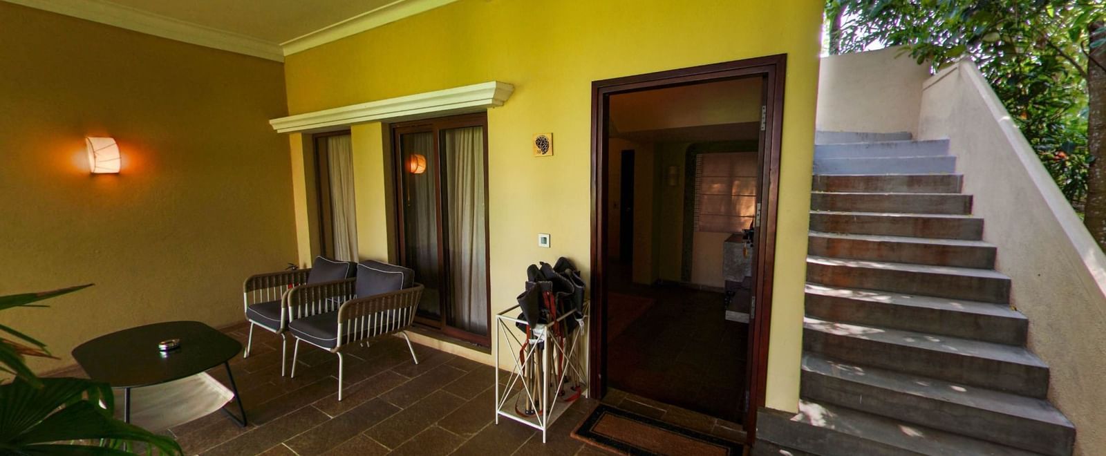 Outdoor view of patio seating, and a staircase at Fireflies Resorts, Kabini.