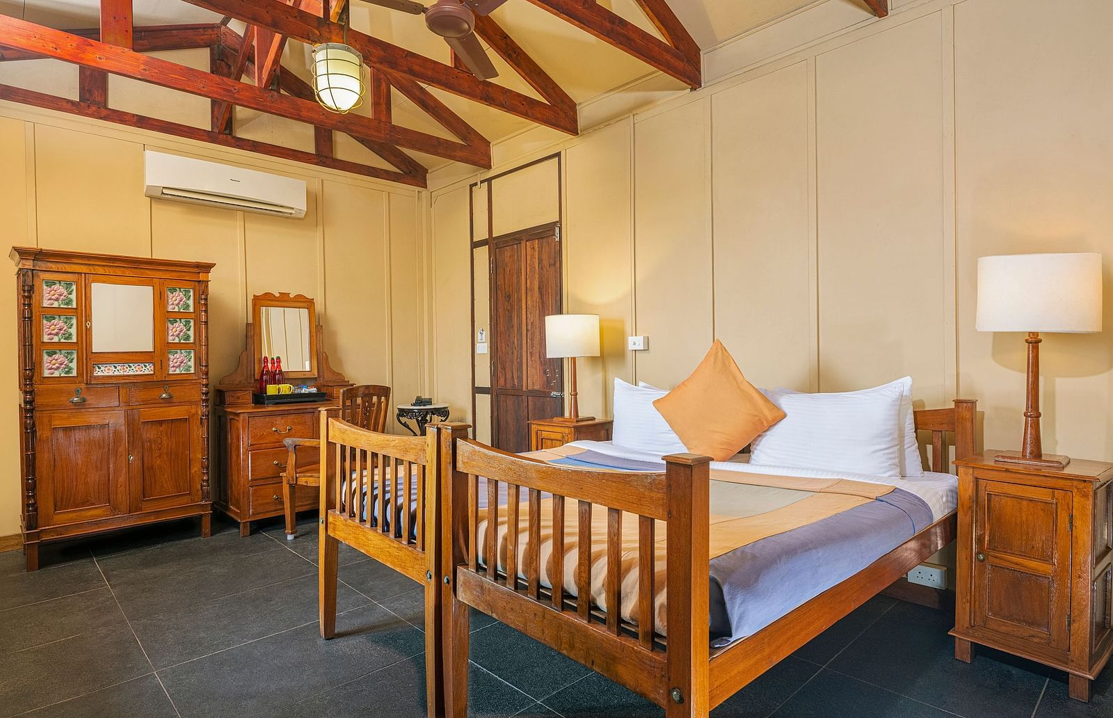 A double bed with side tables and lamps inside a Superior room | Mango Hill, Pondicherry