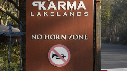 A signage of no hard in zone kept on the wall of the gate - Karma Lakelands.