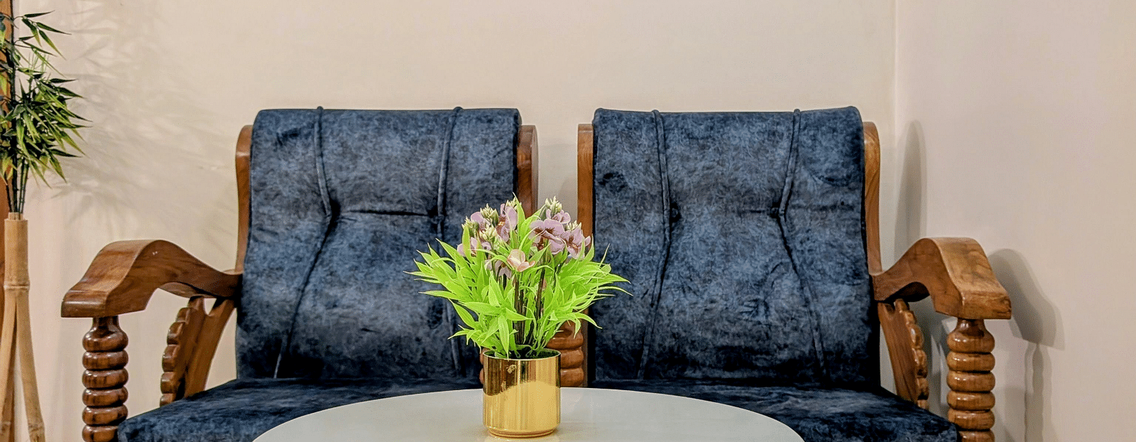 image of a common seating area at the pool side cottage featuring a blue coloured cushioned couch