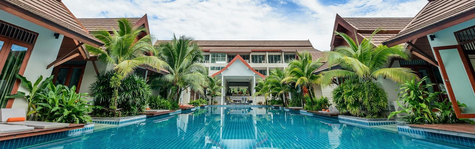 A facade image of a swimming pool in front of a property