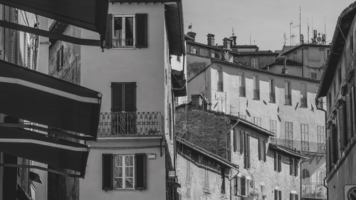 black and white picture of buildings and the sky in the background