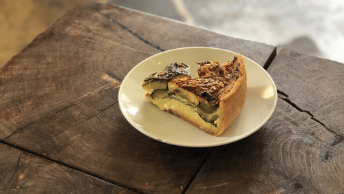 A slice of cake on a plate on a wooden table