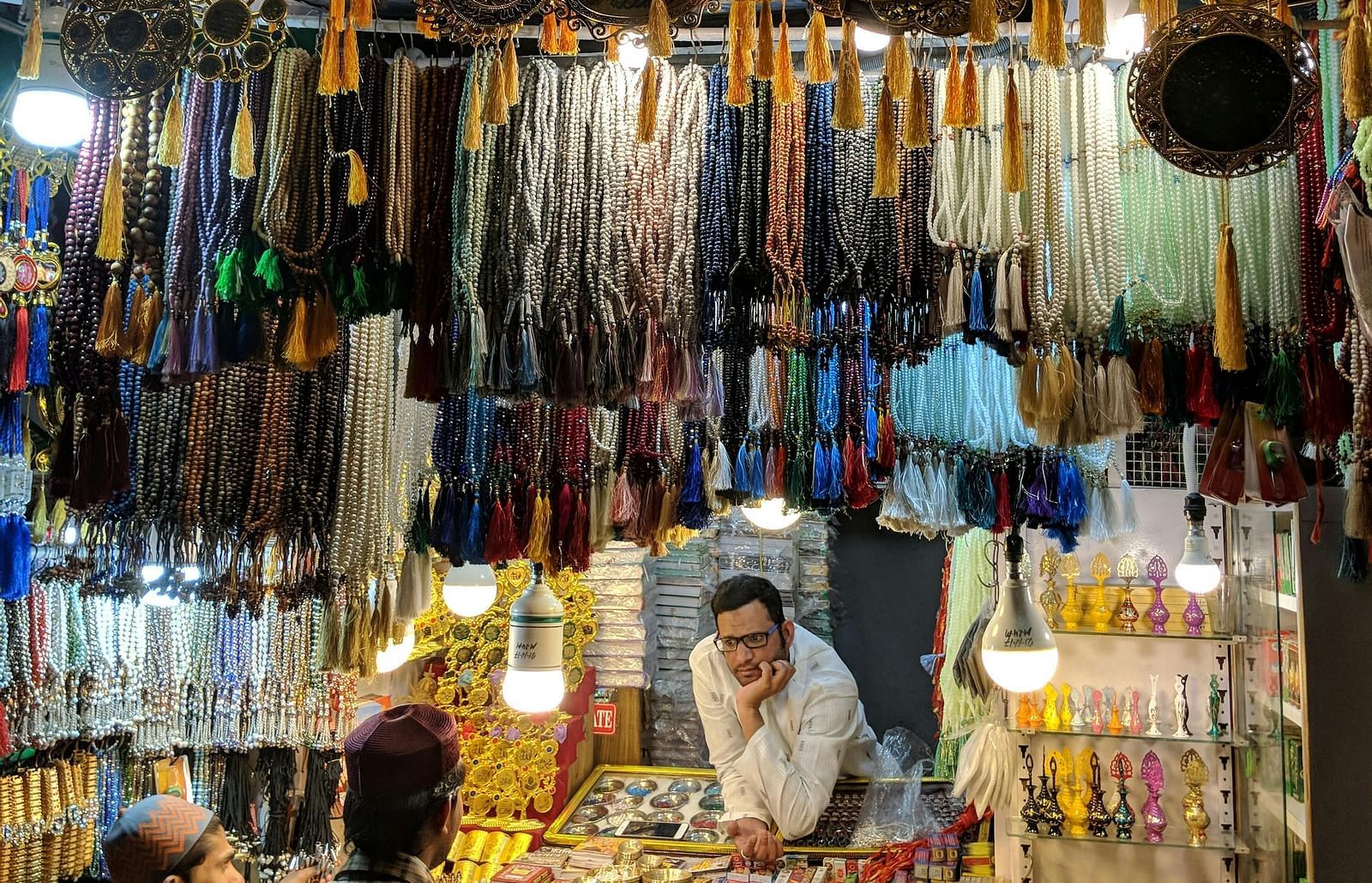 An image of ornament shop with several kind of accessories presented by the shop keeper