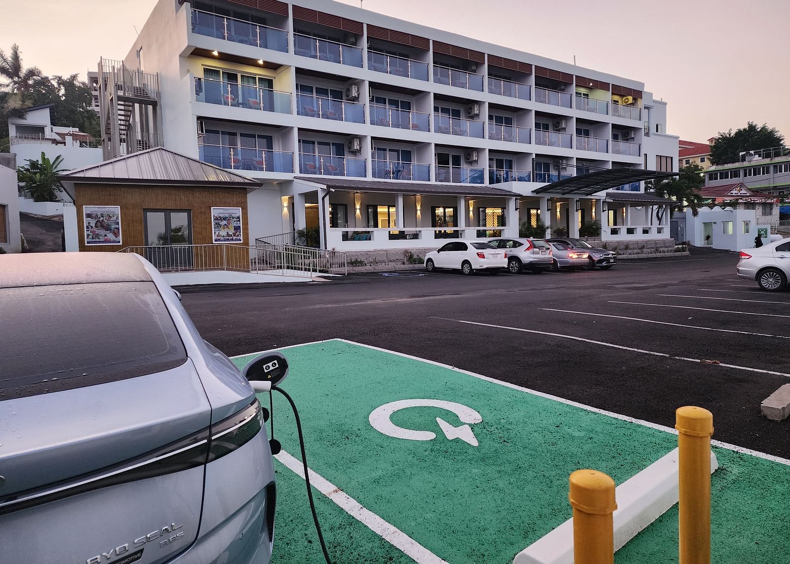 A hotel exterior with an electric car charging station in the parking lot - Hotel 39, Jamaica