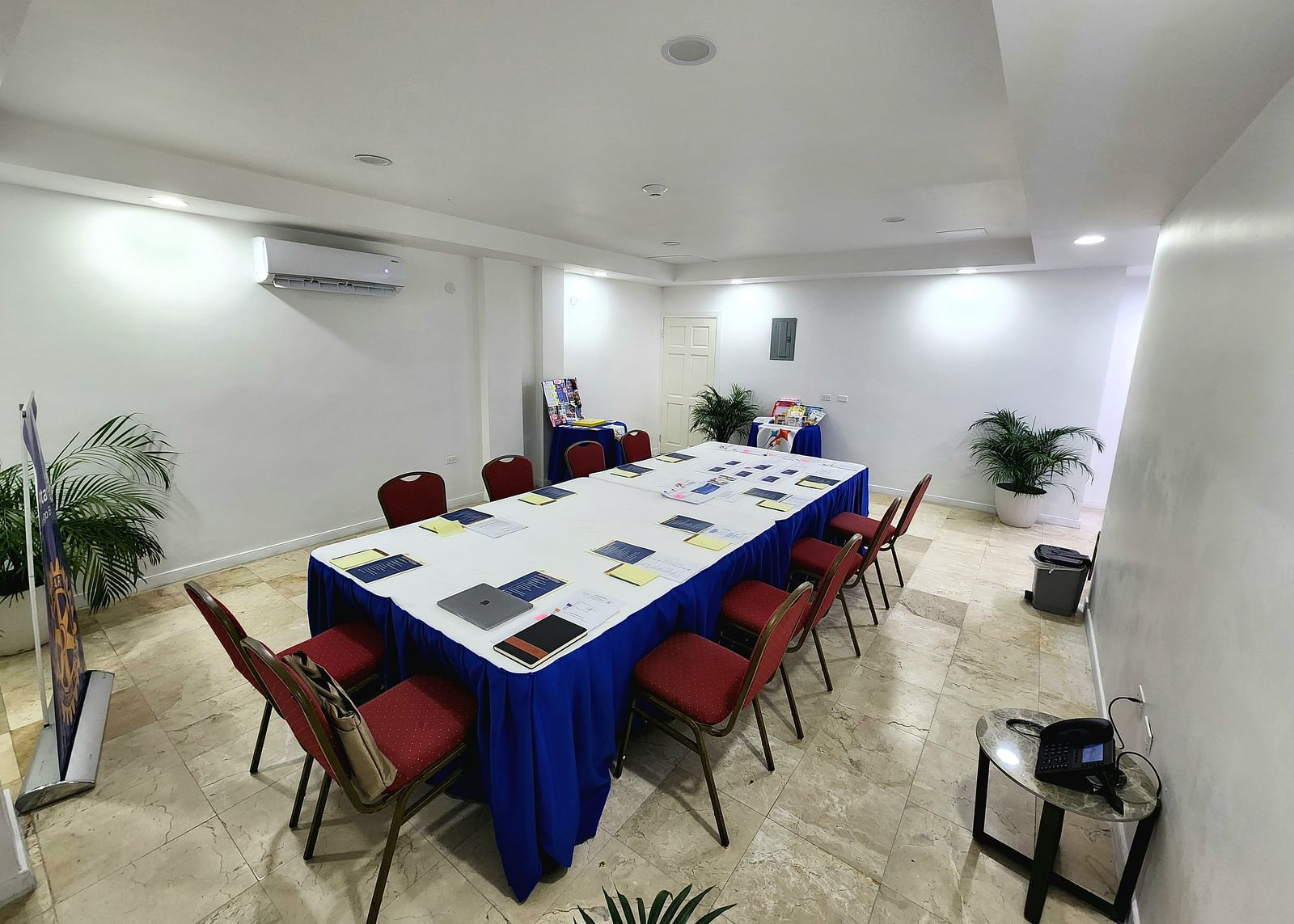 A clean, modern meeting space in Montego Bay with red chairs and a white conference table - Hotel 39, Jamaica (Montego Bay)