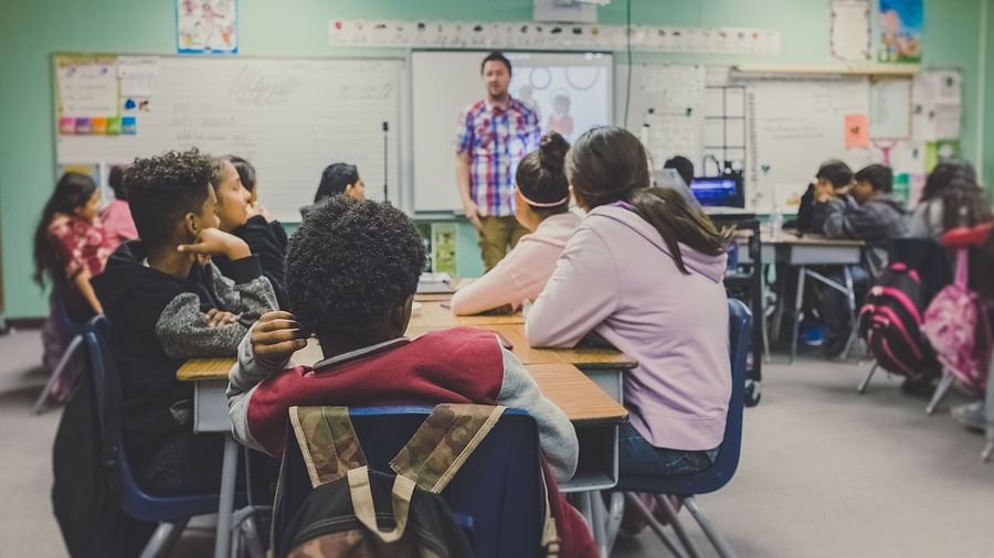 A classroom where students are looking at the teacher