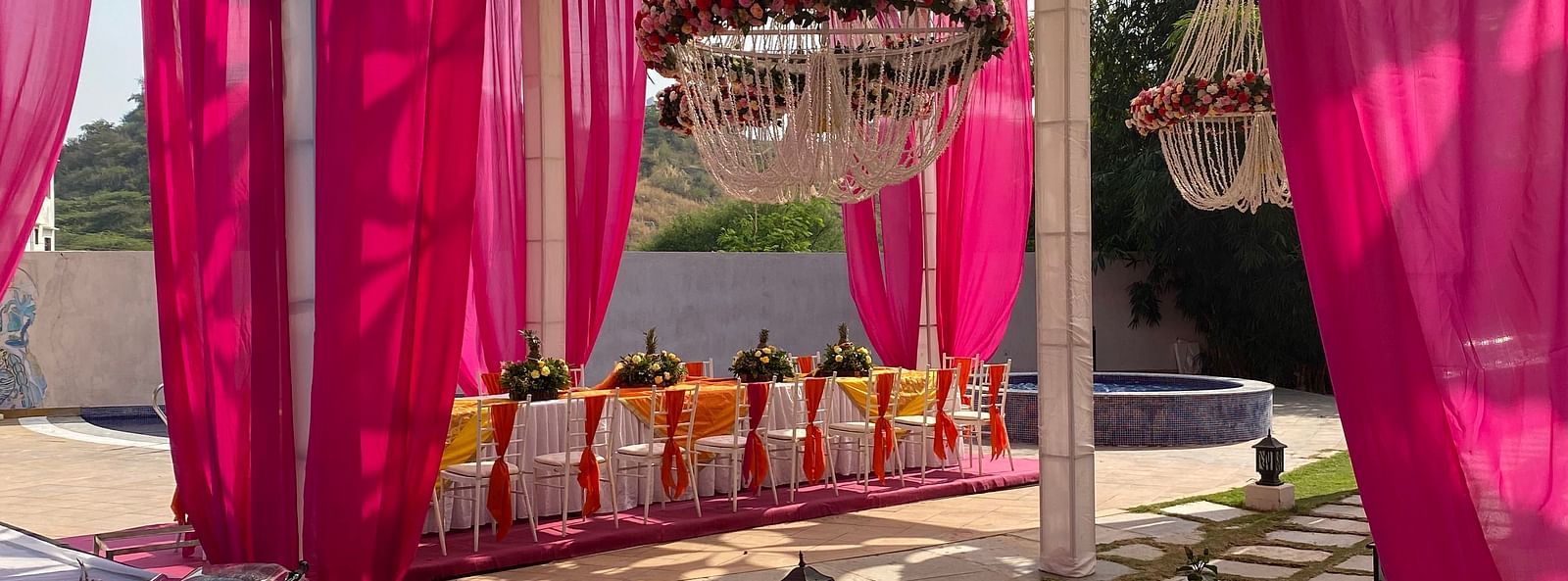 Tent with drapes, stone floor, and decorative lighting.