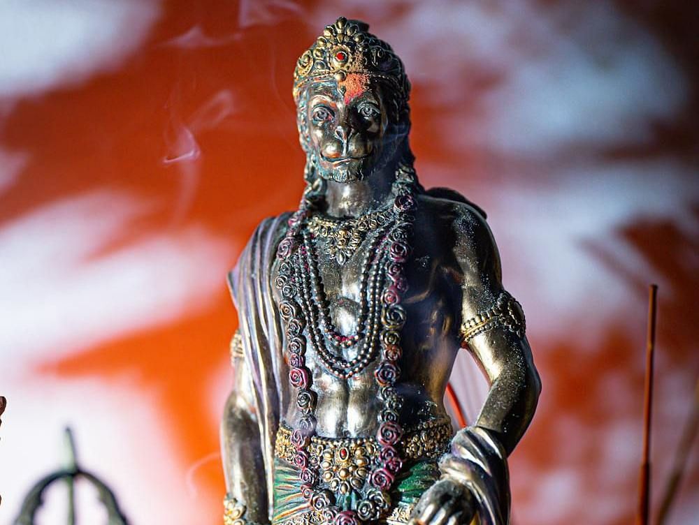 Image of Hanuman with incense burning behind the figure