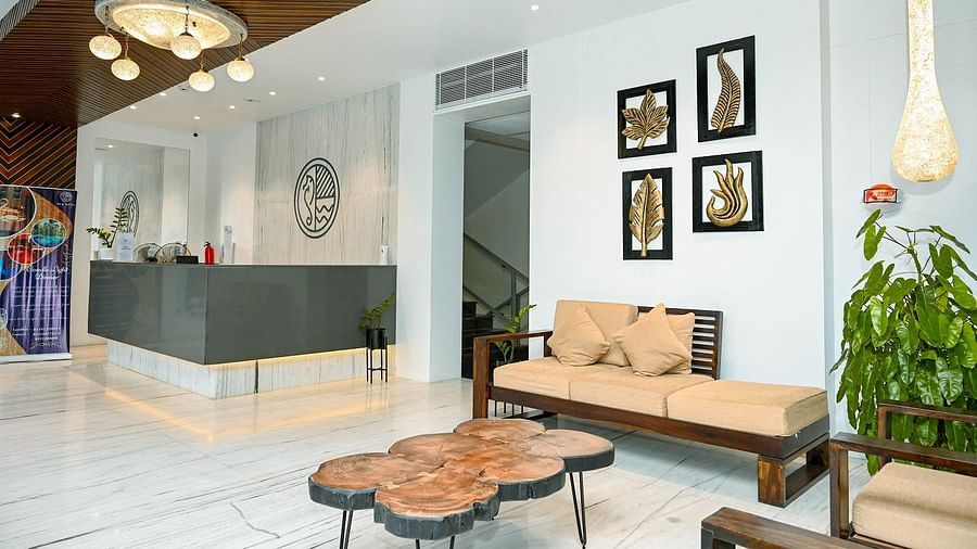 A chic hotel reception with modern furniture, decorative lighting, and wall art - Sea Hills Hotels, Sri Vijayapuram (Port Blair)
