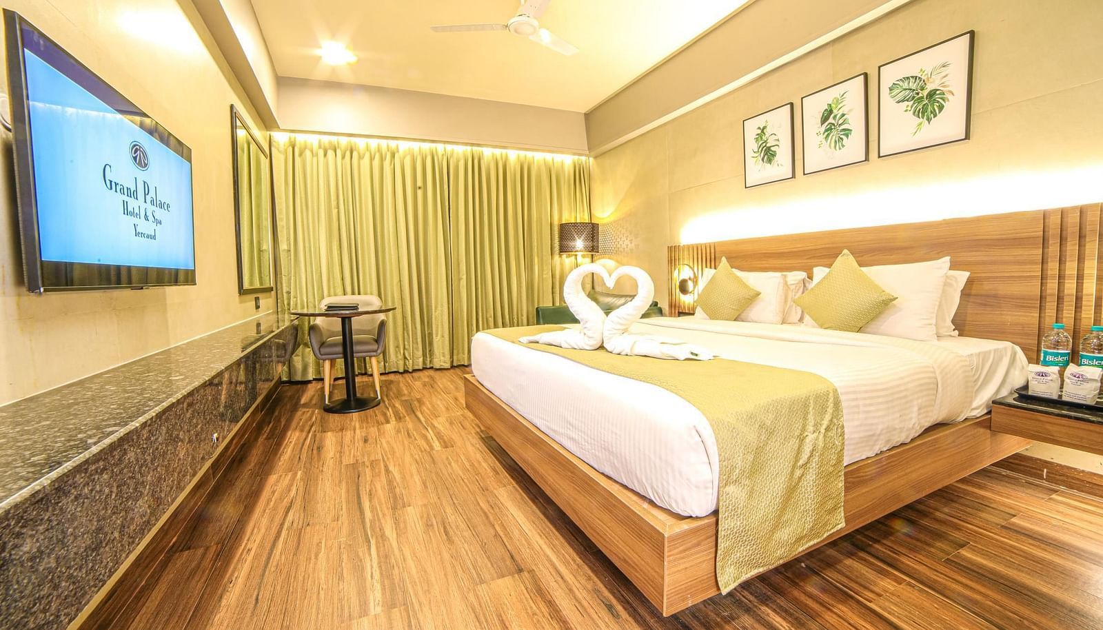 Side view of the double bed and a TV in the Sunrise Room at Grand Palace, Yercaud