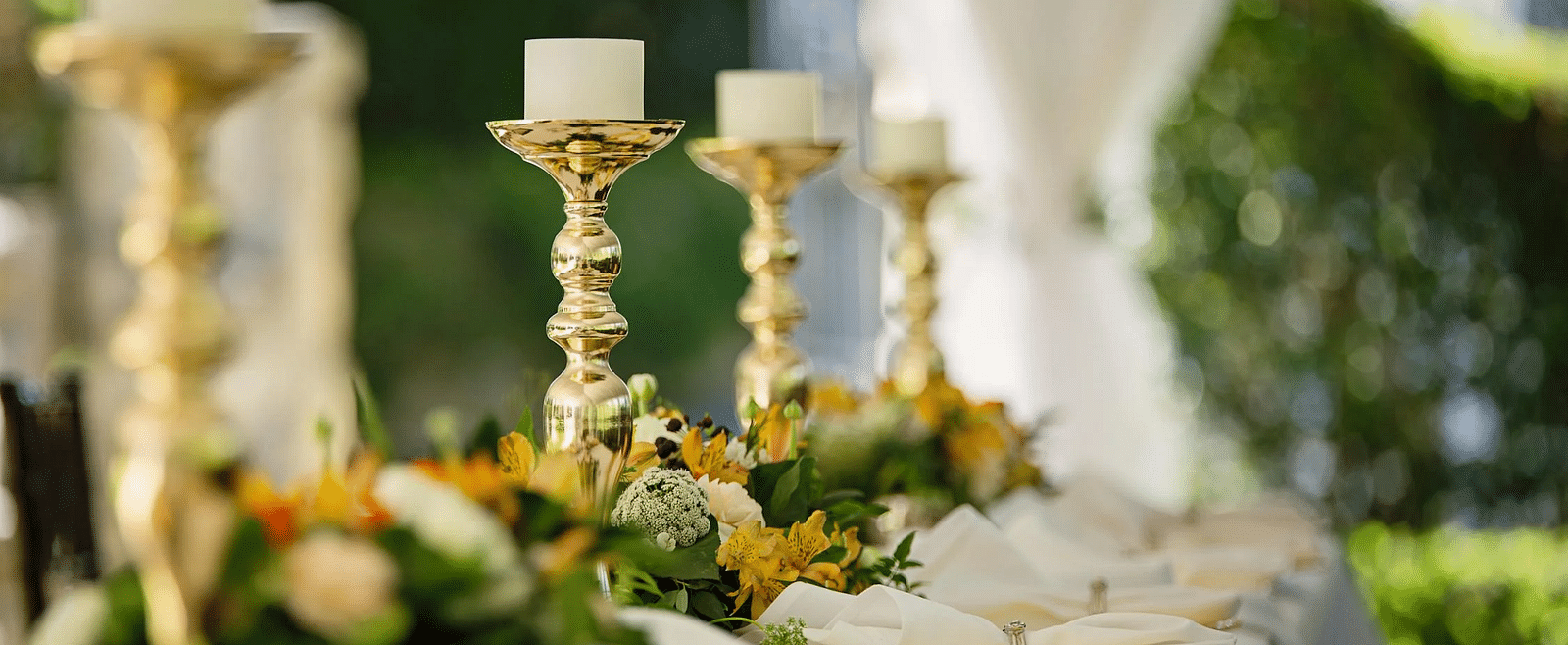 Image of a table with candles and cutlery placed on it.