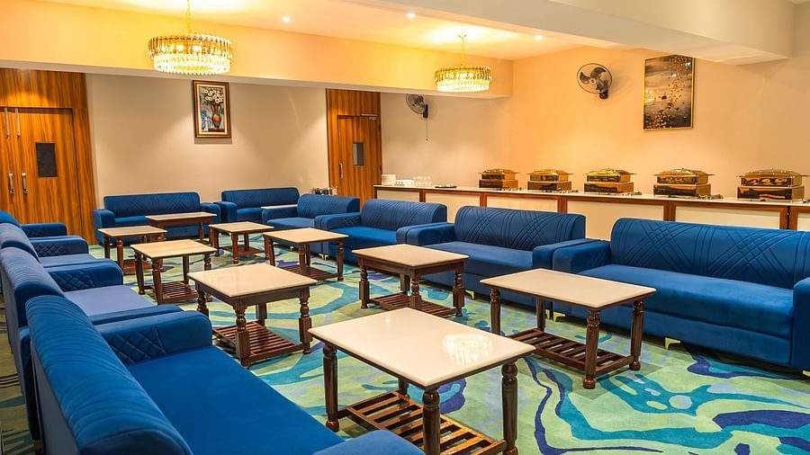 blue sofas and small coffee table arranged in a hall - Onyx Hall