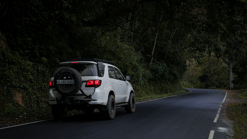 A 4-wheeler on halt on a forest road like that during a journey from Munnar to Thekkady