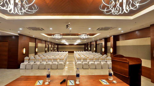 Theatre style seating arrangements with a desk on the podium inside the Banquet hall - VITS Devbhumi, Dwarka