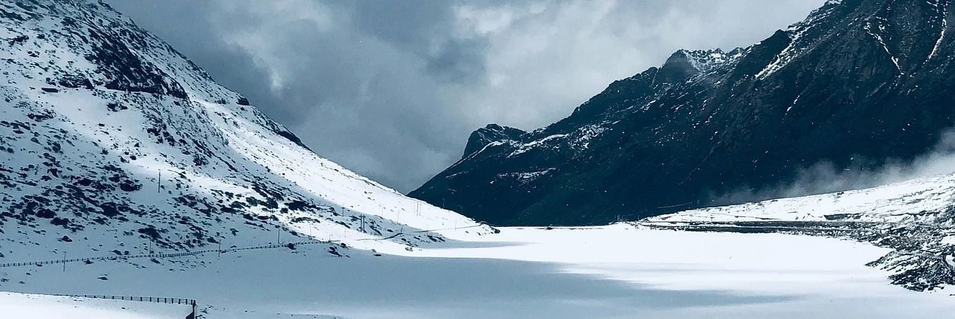 Snow-covered mountain peaks under blue sky with pristine white landscape in high-altitude region