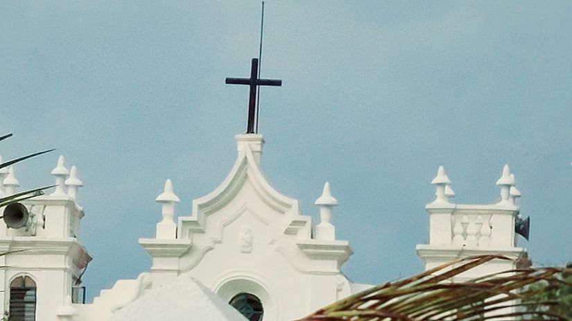 The Holy Cross situated at the building top of a Church