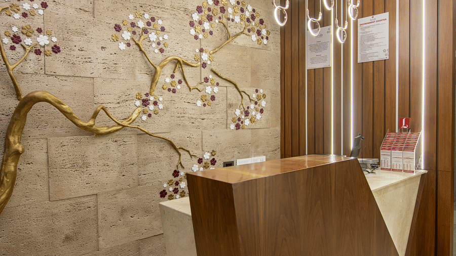 An abstract view of a hotel corridor with unique wall decorations - SK Lords Inn Ahmedabad