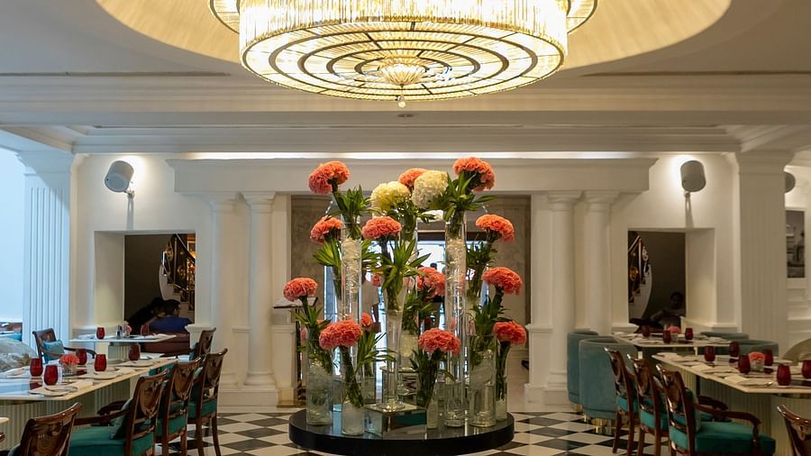 An image of a lobby with an elegant chandelier hanging from the ceiling - Claridges Collection