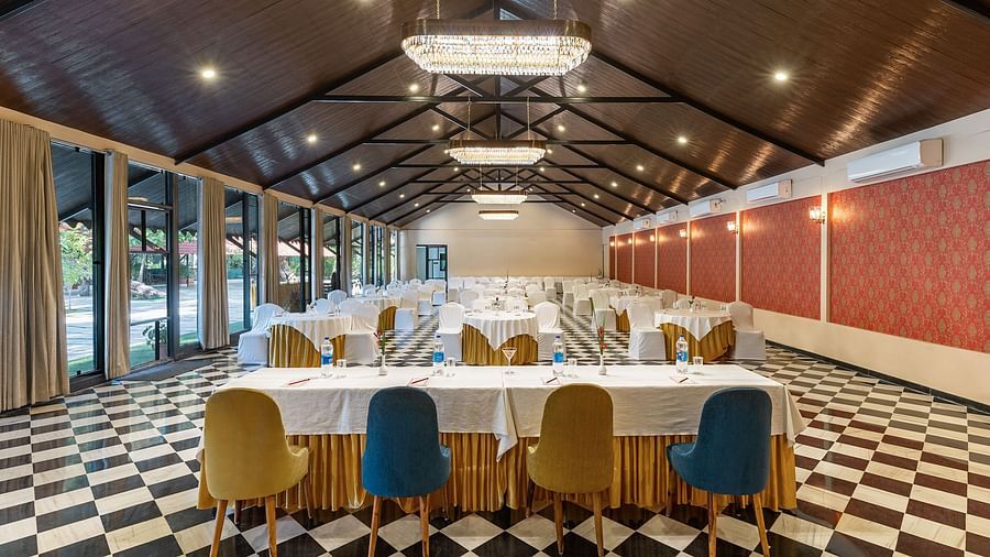 image featuring an expansive banquet hall from the back of the table that receives ample natural light from the window panel on the left