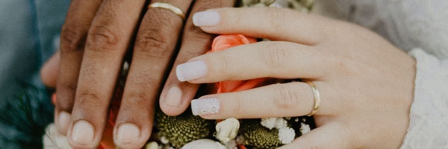 bride and groom showing off their wedding rings