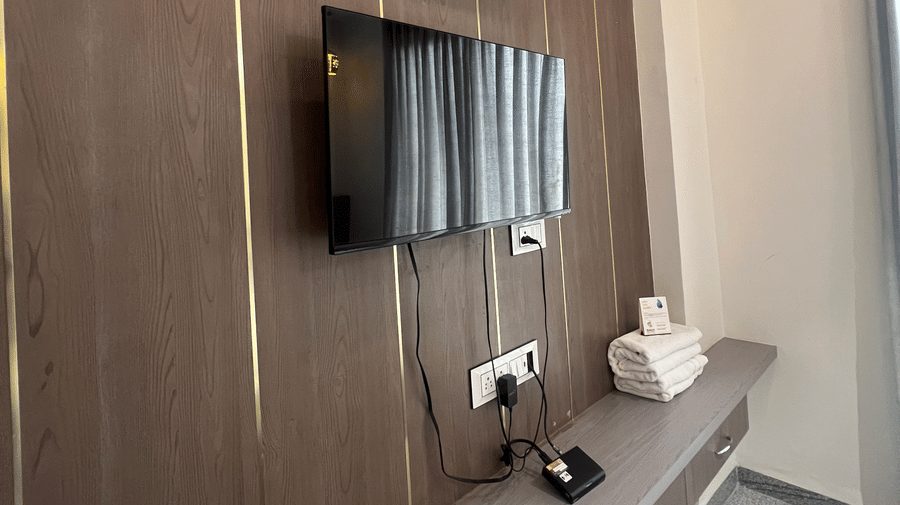 Wall-mounted TV right below the wall-mounted AC in the Superior Room with Mountain View at Daksh The Valley Resort, Saputara.